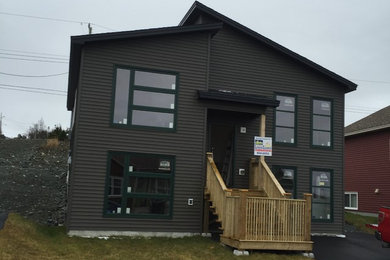 Small contemporary gray split-level vinyl house exterior idea in Other with a shed roof and a shingle roof