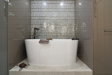 Inspiration for a mid-sized contemporary master gray tile and porcelain tile porcelain tile and gray floor freestanding bathtub remodel in Miami with flat-panel cabinets, light wood cabinets, gray walls, an undermount sink and quartz countertops