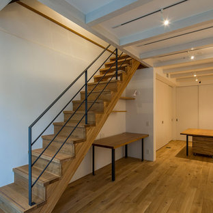 Inspiration for a contemporary look-out basement in Tokyo with white walls and plywood flooring.