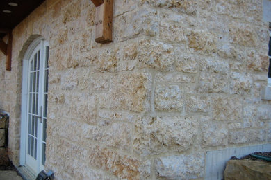Example of a stone exterior home design in Chicago