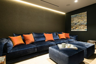 Inspiration for a small modern enclosed home theatre in London with green walls, carpet, a wall-mounted tv and beige floor.