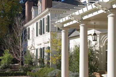 Inspiration for a large timeless white two-story wood house exterior remodel with a clipped gable roof and a shingle roof