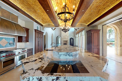 Huge mountain style travertine floor and beige floor eat-in kitchen photo in Miami with an undermount sink, beaded inset cabinets, dark wood cabinets, granite countertops, terra-cotta backsplash, paneled appliances, an island and multicolored countertops
