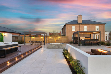 Design ideas for a medium sized contemporary back terrace in Essex with feature lighting.