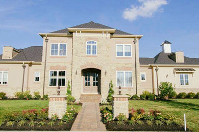 Large traditional beige two-story mixed siding house exterior idea in Columbus with a hip roof and a shingle roof