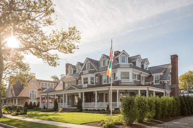 Example of a huge classic gray three-story wood exterior home design in New York