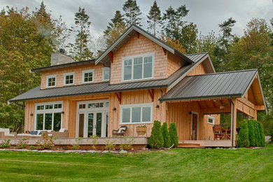 Example of a mid-sized arts and crafts yellow two-story wood gable roof design in Seattle
