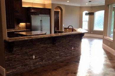 Elegant open concept concrete floor family room photo in Sacramento with a stone fireplace