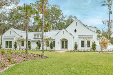 Huge mediterranean two-story house exterior idea in Jacksonville with a metal roof