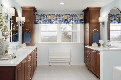 Huge transitional master beige tile and marble tile porcelain tile, beige floor and single-sink bathroom photo in Boston with recessed-panel cabinets, medium tone wood cabinets, a bidet, blue walls, an undermount sink, quartz countertops, a hinged shower door, beige countertops and a built-in vanity