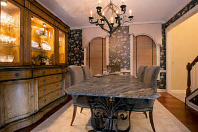 Example of a mid-sized classic medium tone wood floor enclosed dining room design in Columbus with no fireplace