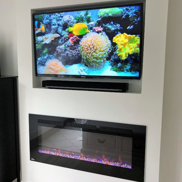 Floating fireplace and t.v. niche in Master Bedroom