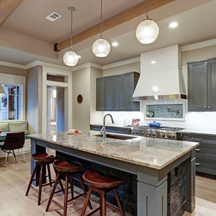 Transitional eat-in kitchen ideas - Transitional galley light wood floor and beige floor eat-in kitchen photo in Houston with an undermount sink, recessed-panel cabinets, gray cabinets, white backsplash, subway tile backsplash, stainless steel appliances and an island