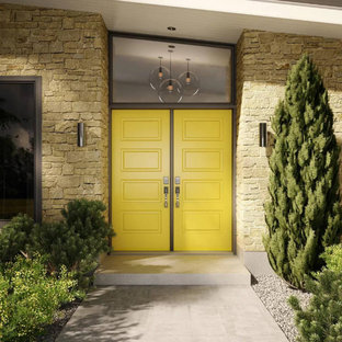 Inspiration for an eclectic front door in Montreal with beige walls, concrete floors, a double front door, a yellow front door and grey floor.