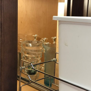 Trash pull-out with storage in blind corner.