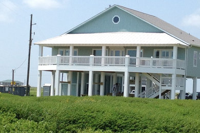 Example of a beach style home design design in Houston