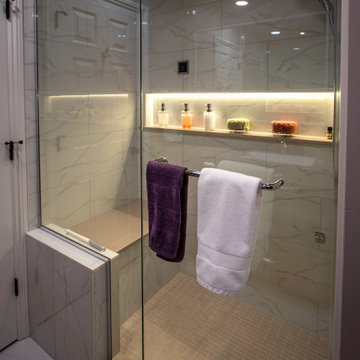 Spa Bath with Tile Steam Shower, Walnut Cabinetry and Solid Surface Countertops