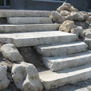 Coral steps with native Florida cap rock boulder retaining wall