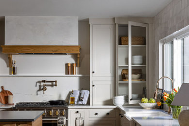 Inspiration for a mid-sized modern u-shaped kitchen pantry in Atlanta with a farmhouse sink, beaded inset cabinets, white cabinets, laminate benchtops, stainless steel appliances, multiple islands, white benchtop and exposed beam.