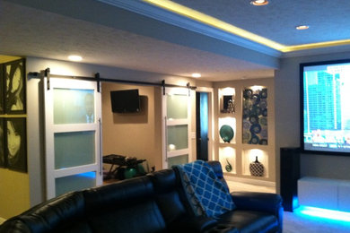 Inspiration for a large modern underground carpeted basement remodel in Omaha with gray walls