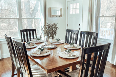 Inspiration for a mid-sized transitional medium tone wood floor and brown floor enclosed dining room remodel in Boston with white walls and no fireplace