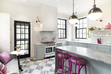 Example of a large trendy galley marble floor and white floor enclosed kitchen design in Louisville with an undermount sink, flat-panel cabinets, blue cabinets, marble countertops, white backsplash, marble backsplash, stainless steel appliances, an island and white countertops