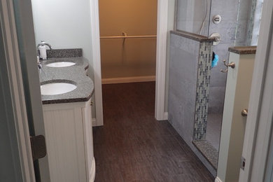 Mid-sized transitional master gray tile and matchstick tile dark wood floor alcove shower photo in Other with furniture-like cabinets, white cabinets, a two-piece toilet, gray walls, an undermount sink and quartz countertops