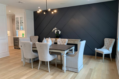 Inspiration for a large transitional light wood floor, beige floor and shiplap wall dining room remodel in New York with gray walls