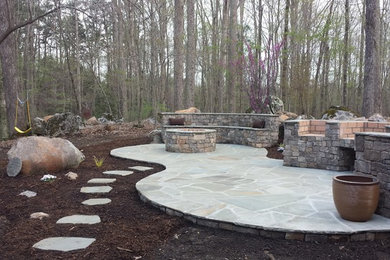 Example of a small southwest backyard stone patio kitchen design in Raleigh with no cover