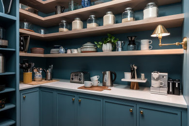 Walk-in closet - mid-sized transitional gender-neutral medium tone wood floor and white floor walk-in closet idea in Atlanta with shaker cabinets and blue cabinets