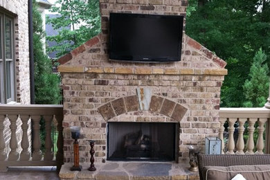 Example of a mid-sized classic backyard brick patio design in Atlanta with a fire pit