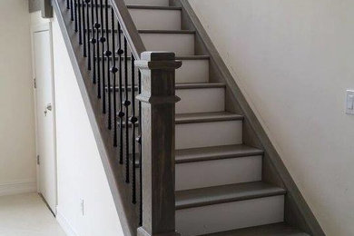 Inspiration for a mid-sized timeless wooden u-shaped mixed material railing staircase remodel in Miami with painted risers