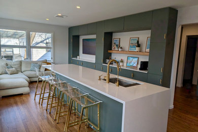 Inspiration for a large contemporary medium tone wood floor and brown floor kitchen remodel in New York with an undermount sink, flat-panel cabinets, green cabinets, quartzite countertops, white backsplash, quartz backsplash, stainless steel appliances and white countertops