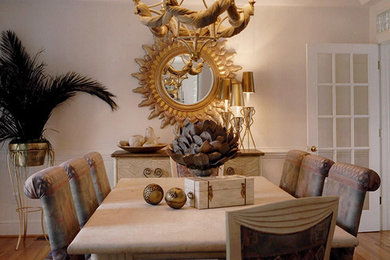 Example of a large trendy light wood floor enclosed dining room design in Charlotte with white walls and no fireplace