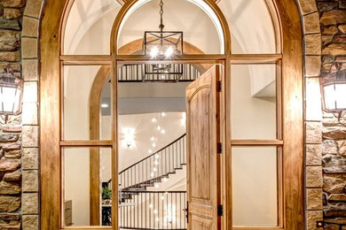Entryway - huge transitional ceramic tile entryway idea in Denver with white walls and a light wood front door