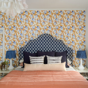 Vibrant Guest Bedroom with Blue Tulip Wallpaper and Coral Accents