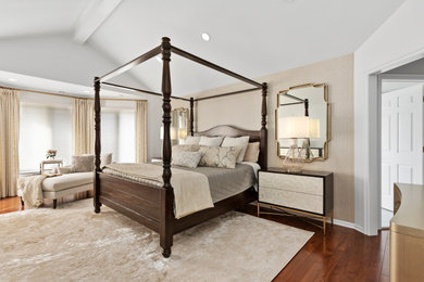 Example of a large transitional master medium tone wood floor and wallpaper bedroom design in Detroit with beige walls