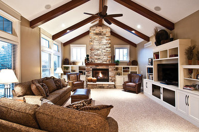 Inspiration for a large country open concept living room in St Louis with brown walls, carpet, a standard fireplace, a stone fireplace surround and a built-in media wall.