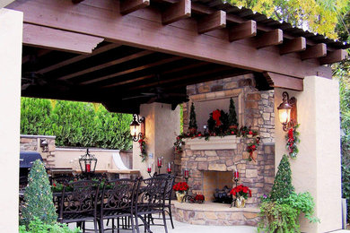 Inspiration for a mid-sized arts and crafts backyard patio in Other with a fire feature, concrete slab and a pergola.