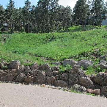 Boulder Wall Outlining Driveway