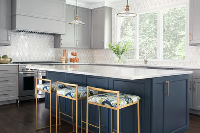 Kitchen - transitional l-shaped dark wood floor and brown floor kitchen idea in Charlotte with shaker cabinets, gray cabinets, white backsplash, stainless steel appliances, an island and white countertops