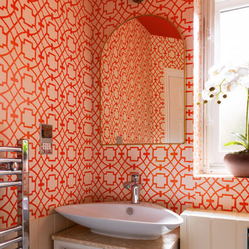 Vibrant and Playful: A Bold Orange Powder Room Transformation