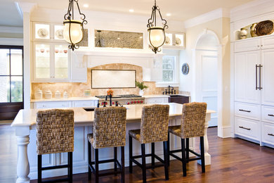 Traditional kitchen in Charleston with glass-front cabinets and a farmhouse sink.