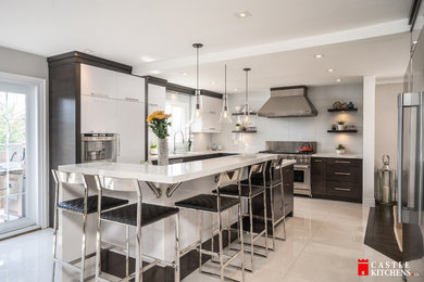 Inspiration for a medium sized modern l-shaped kitchen/diner in Toronto with a double-bowl sink, flat-panel cabinets, dark wood cabinets, engineered stone countertops, blue splashback, glass tiled splashback, stainless steel appliances, porcelain flooring, an island, white floors and white worktops.