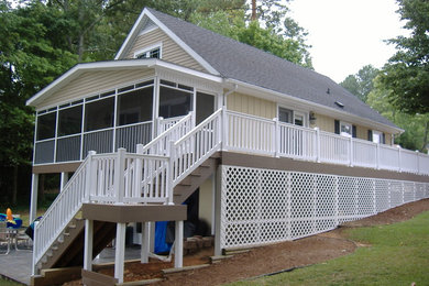 This is an example of a mid-sized traditional screened-in back porch design in Other.