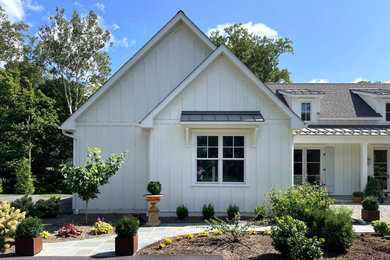 Cottage white one-story mixed siding and board and batten exterior home photo in Other with a mixed material roof and a gray roof