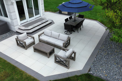 Patio - mid-sized contemporary backyard concrete paver patio idea in Other