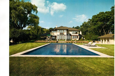 Pool fountain - mid-sized contemporary backyard stone and rectangular lap pool fountain idea in New York