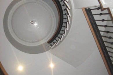 Inspiration for a large wooden spiral staircase remodel in New York with wooden risers