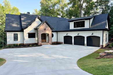 Mid-sized minimalist white two-story mixed siding and board and batten house exterior photo in Atlanta with a shingle roof and a black roof